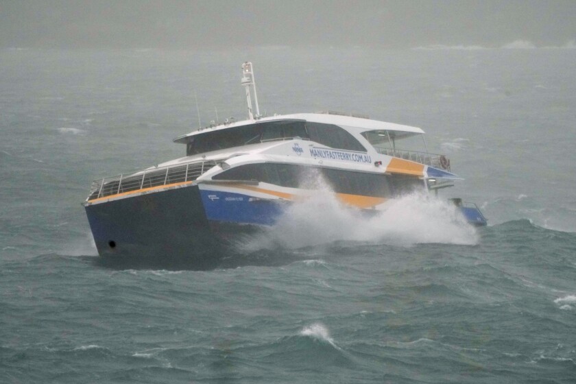 The Manly Ferry makes its way through heavy swells across Sydney Harbour, Australia, Sunday, July 3, 2022. A severe weather warning for heavy rainfall and strong winds has been issued for Sydney, as parts of NSW have received more than their monthly average rainfall within hours this weekend. (AP Photo/Mark Baker)