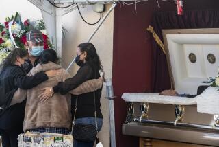 EAST LOS ANGELES, CA - DECEMBER 20: Family and friends console each other as they gather at a service for Julio Aguilar at the Continental Funeral Home on Sunday, Dec. 20, 2020 in East Los Angeles, CA. The 74-year-old died Nov 28, 2020 from complications of Covid-19.(Brian van der Brug / Los Angeles Times)