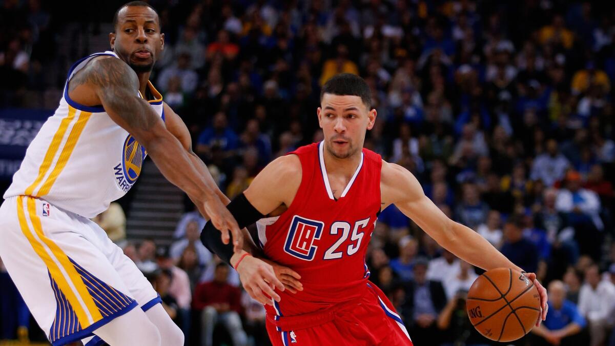 Clippers guard Austin Rivers tries to drive past Warriors forward Andre Iguodala in the first half.