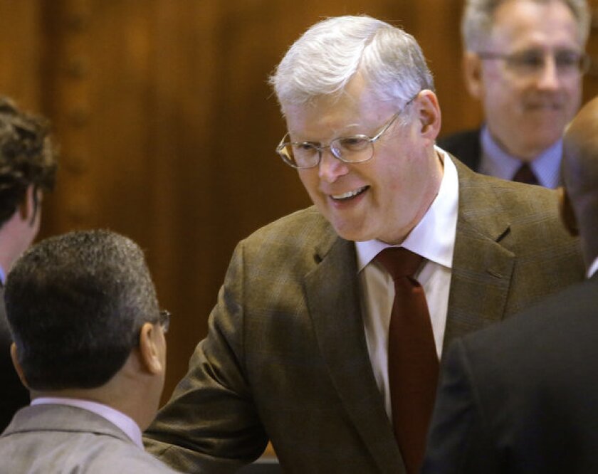 Illinois state Sen. William Haine is congratulated after his bill to legalize medical marijuana passes through the Senate.