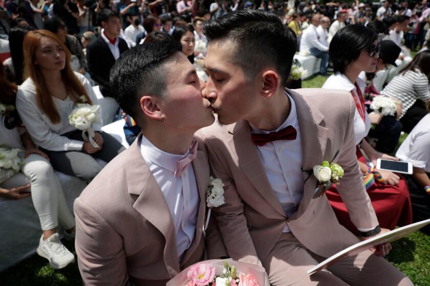 Mandatory Credit: Photo by RITCHIE B TONGO/EPA-EFE/REX (10246216t) A same-sex married couple kiss during the first day of civil registration for same-sex marriage in Taipei, Taiwan, 24 May 2019. Taiwan became the first Asian country to legalize same-sex marriage after a bill was passed on the 17 May 2019. Hundreds of gay and lesbian couples have applied to register for a legal union on the day the bill is to come into effect. First day of civil registration for same-sex marriage in Taipei, Taiwan - 24 May 2019 ** Usable by LA, CT and MoD ONLY **