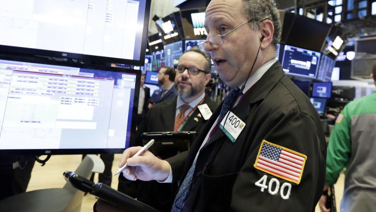 Traders Gordon Charlop, right, and Robert Arciero work on the floor of the New York Stock Exchange on Wednesday,