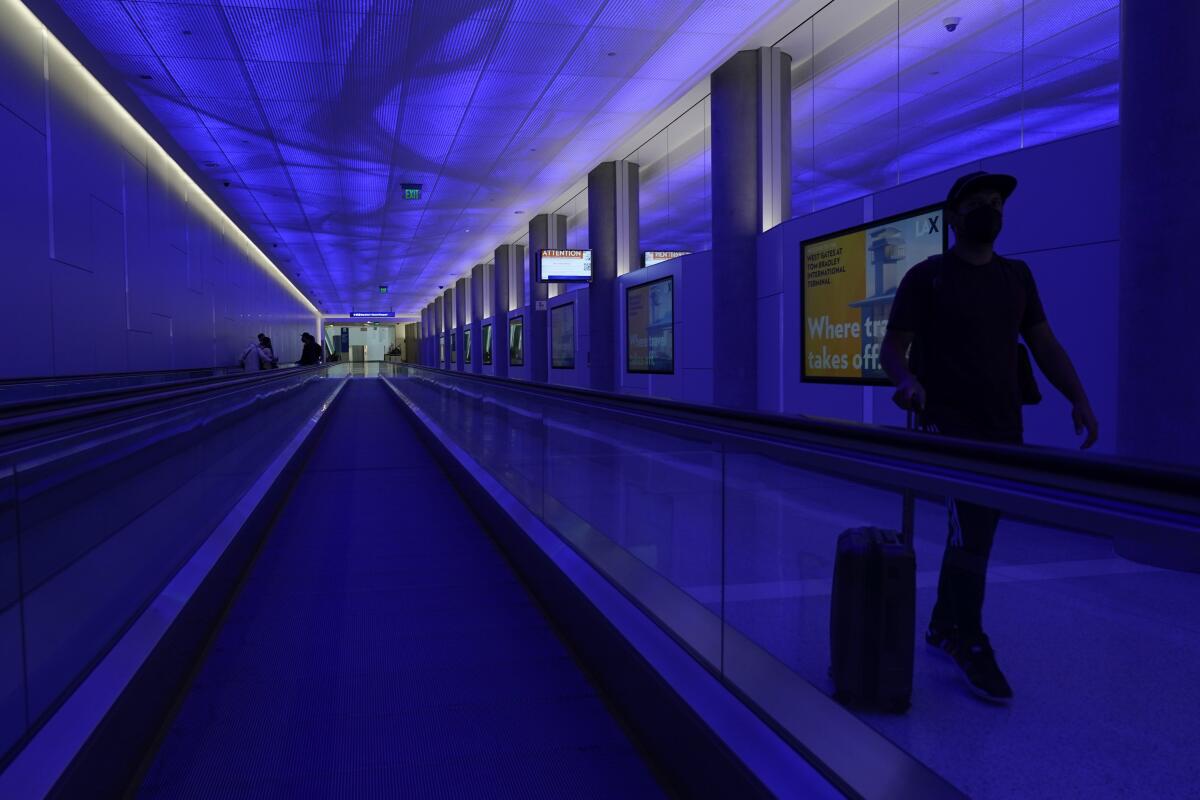 A pedestrian in the passenger tunnel at LAX's West Gates facility