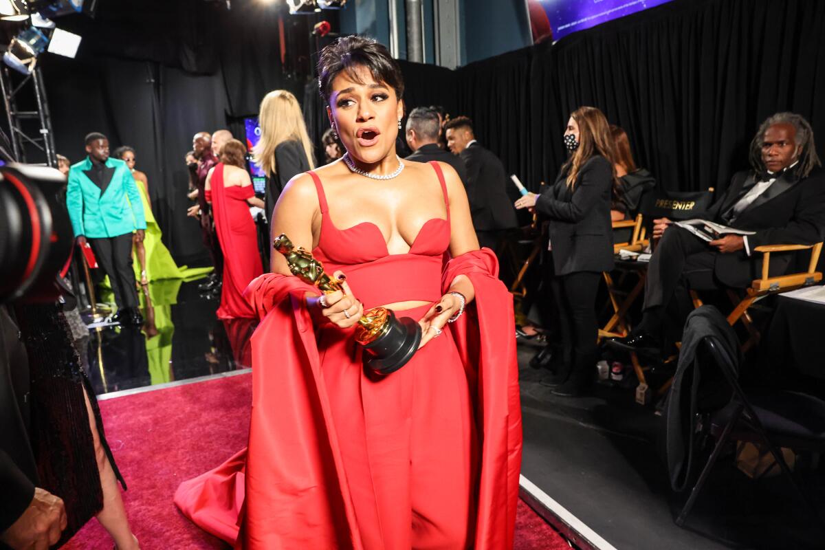 Ariana DeBose holds her Oscar for best supporting actress backstage.