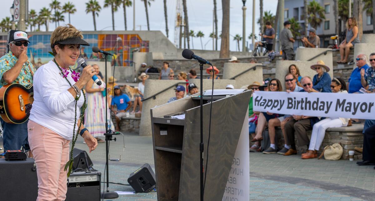 Huntington Beach Mayor Barbara Delgleize shares some thoughts Sunday morning during the annual Blessing of the Waves.