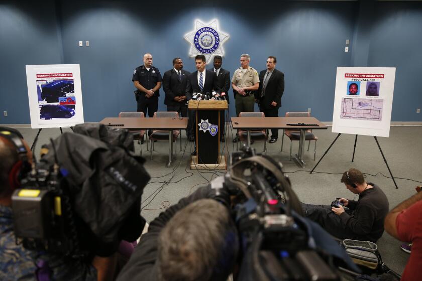 FBI Assistant Director David Bowdich, center, appeals to the public for information about the whereabouts of the San Bernardino attackers after the Dec. 2 massacre.