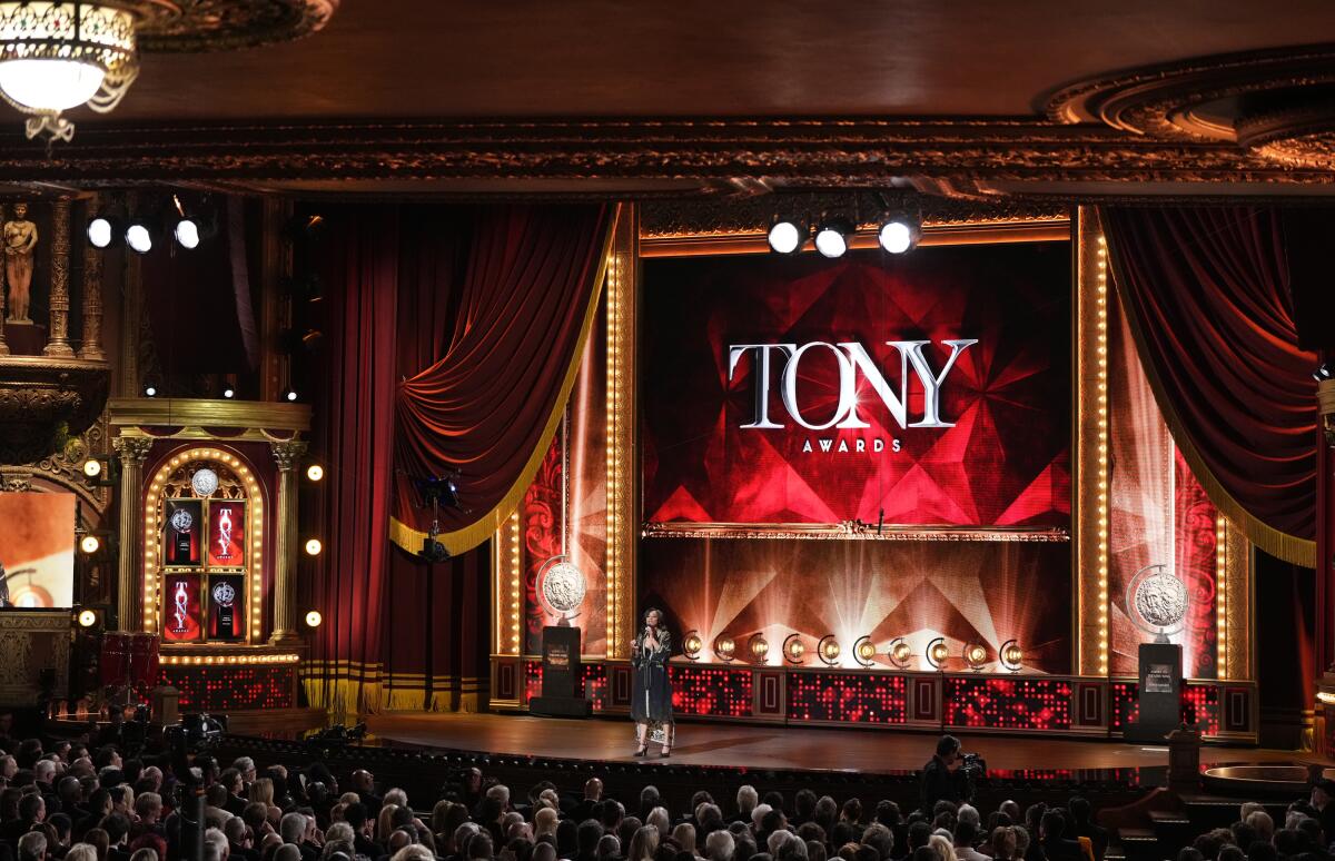 A wide view of the Tony Awards stage with a red screen featuring the word "TONY" in all caps.