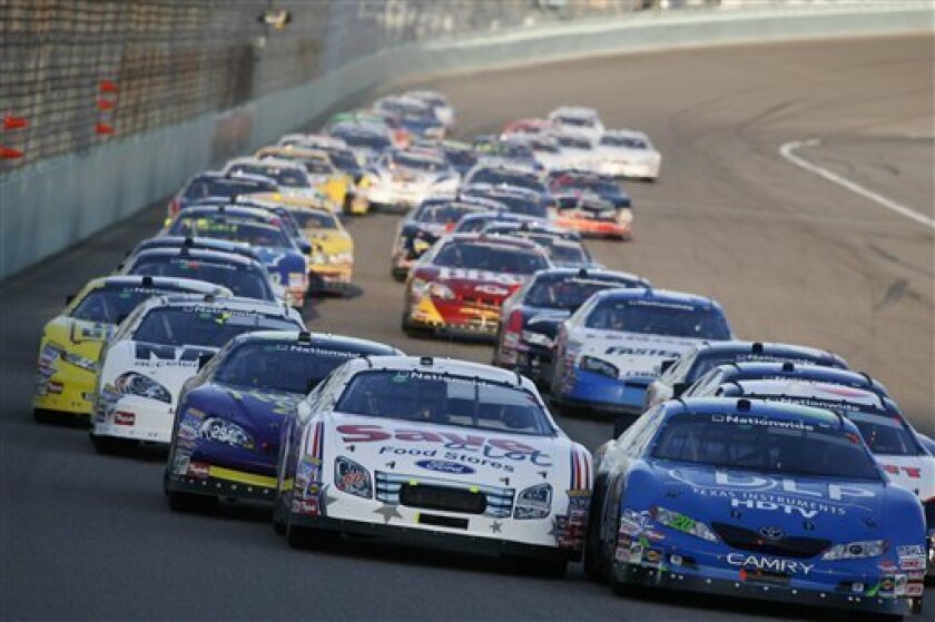 NASCAR drivers Carl Edwards, left, and Joey Logano, right, lead the field at the start of the Nationwide Ford 300 auto race in Homestead, Fla. Saturday, Nov. 15, 2008. (AP Photo/Glenn Smith)