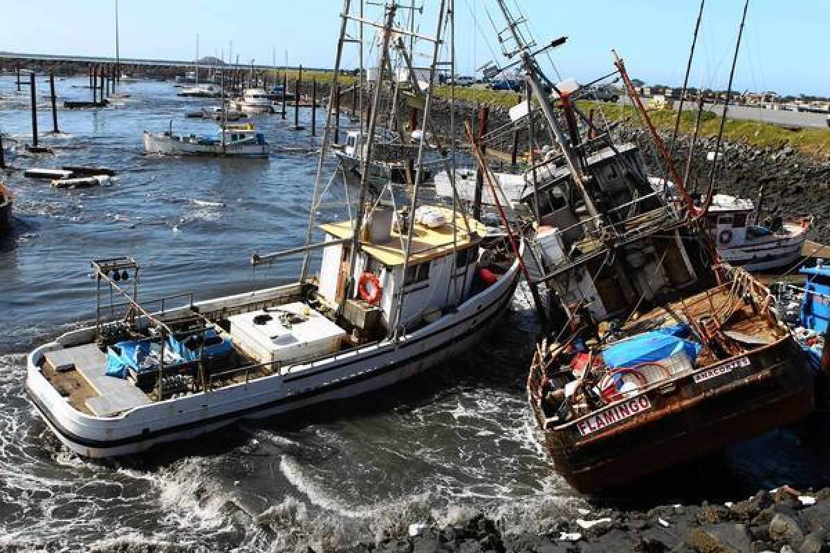 Boats collide with one another after a tsunami surge of water swept through a boat basin in Crescent City, Calif., on March 11, 2011.