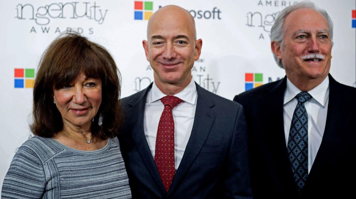 Jackie Bezos, left, and Mike Bezos, right, invested in Amazon in 1995. Their stake could be worth almost $30 billion today.