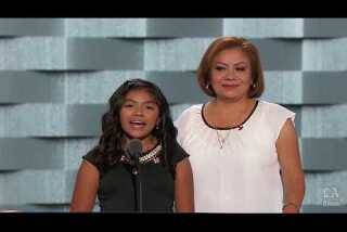 Karla Ortiz, daughter of undocumented parents, speaks with her mother Francisca at the Democratic National Convention