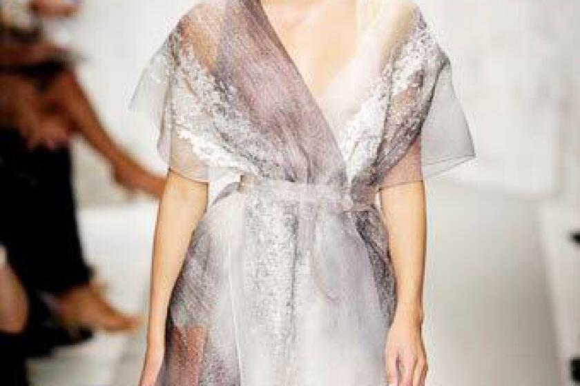 By Booth Moore, Los Angeles Times fashion critic Designers made ample use of sheer fabric insets, panels and layers on the runway. Inspired by the elements, Donna Karan sent out slip skirts and body-clinging tops in stormy-colored, whisper-weight layers of gauze, and dresses draped in cloud-like whirls of tulle. Ralph Lauren layered featherweight, sheer white organdy trench coats and shirts over linen vests, pants and a double-layer cotton organdy pleated skirt. Vera Wang's collection of darkly romantic sheer layers, paired with candied jeweled bibs and spidery chain necklaces was more rock 'n' roll. A black gazar tuxedo vest was an ingenious piece, worn with a charcoal T-shirt and a sheer black organza skirt. Underneath, the model wore a pair of charcoal athletic shorts, similar to Spanx. With all the sheer fabrics this season, we've seen Spanx-like foundations in several collections, including DKNY. (Spanx as outerwear — we'll believe it when we see it.)