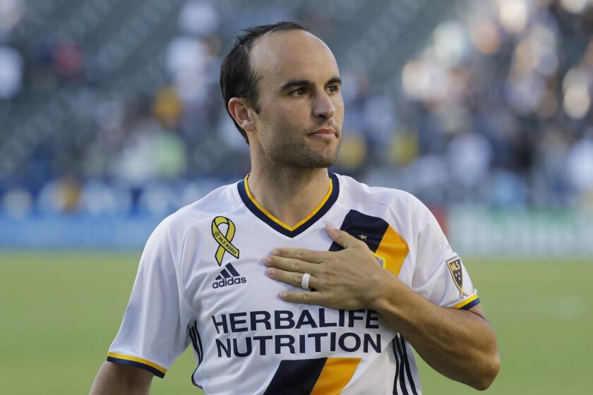 FILE - Los Angeles Galaxy's Landon Donovan acknowledges fans after the team's MLS soccer match against Orlando City in Carson, Calif., Sept. 11, 2016. Landon Donovan is teaming with Clint Dempsey again at a World Cup. The pair, who share the American record of 57 international goals, will work for Fox at this year’s tournament in Qatar. (AP Photo/Jae C. Hong. File)