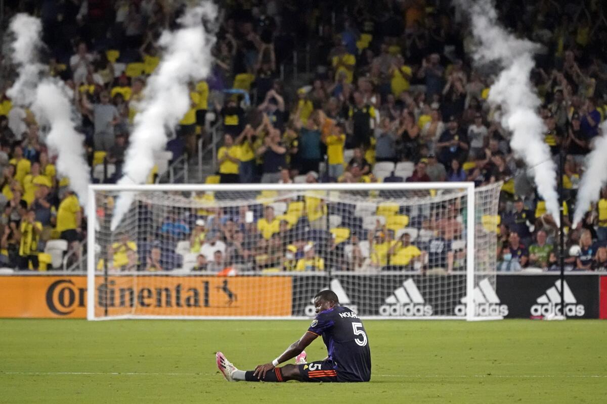 Seattle Sounders' Nouhou Tolo sits on the pitch after a 1-0 loss to the Nashville SC in an MLS soccer match Wednesday, July 13, 2022, in Nashville, Tenn. (AP Photo/Mark Humphrey)