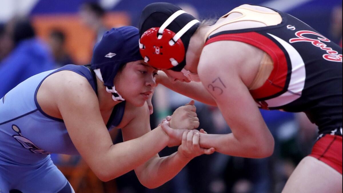 Corona del Mar High's Kiersten Muse, left, battles Rancho Verde's Vanessa Gonzalez in the CIF Southern Section girls' wrestling finals at Eastvale Roosevelt High on Feb. 9, 2018.