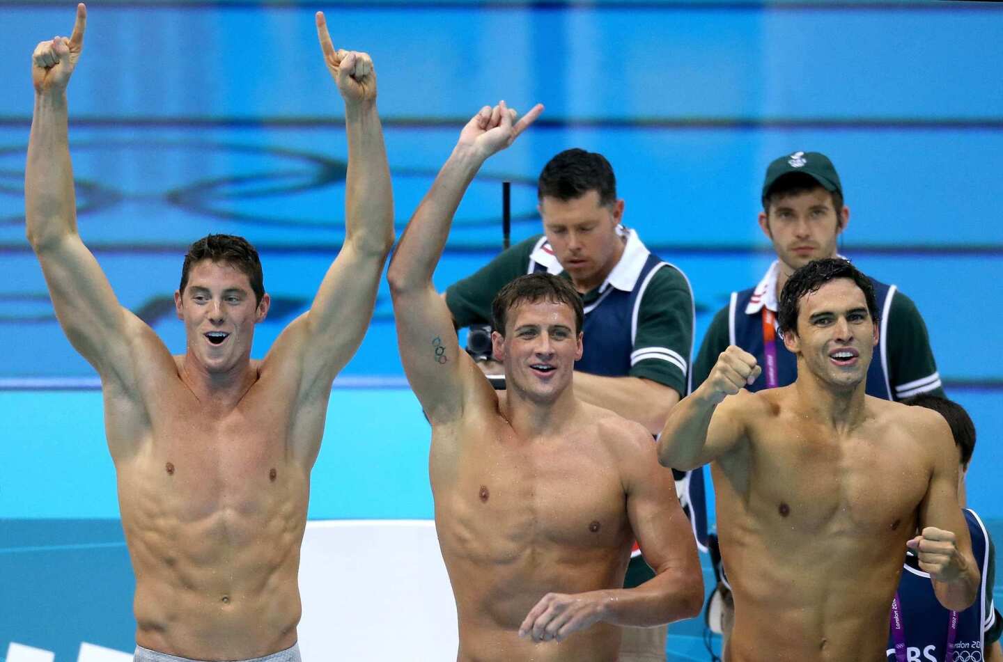 Conor Dwyer, Ryan Lochte and Ricky Berens cheer teammate Michael Phelps as the U.S. men's 8000m freestyle relay team wins the gold medal.