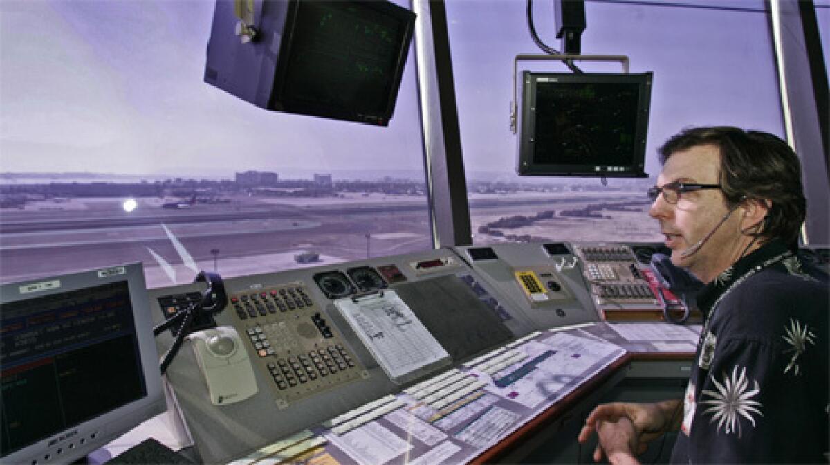 IN THE TOWER: Air traffic controller Mike Gage at work in San Diego. Aviation experts say the systems are not the whole solution but are part of a layered approach to limit close calls.