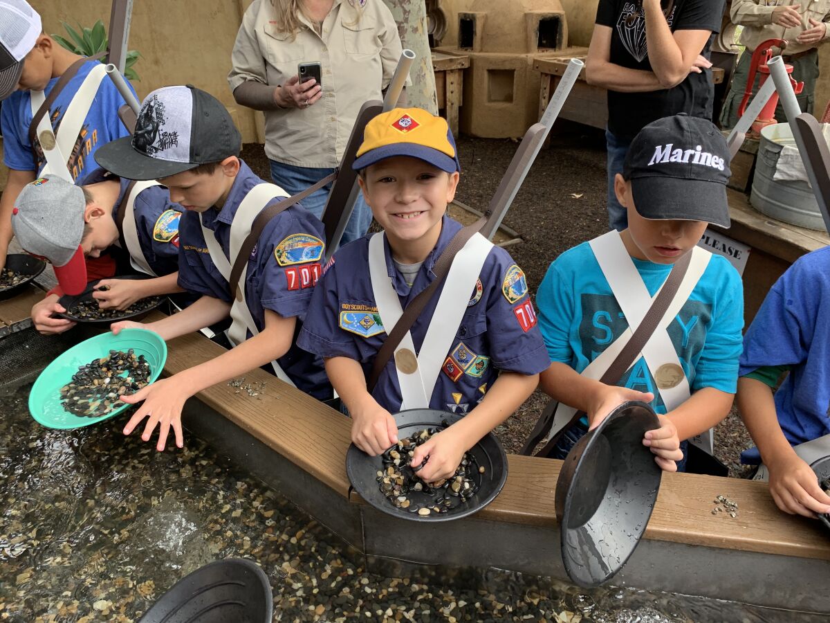 Cub Scout Karsten Agle of Fallbrook Pack 704, center, pans for gold at the Mormon Battalion Historic Site in Old Town San Diego on Sept. 28 as part of his work toward earning the Cub Scout Mormon Battalion Trail High Adventure Award. 