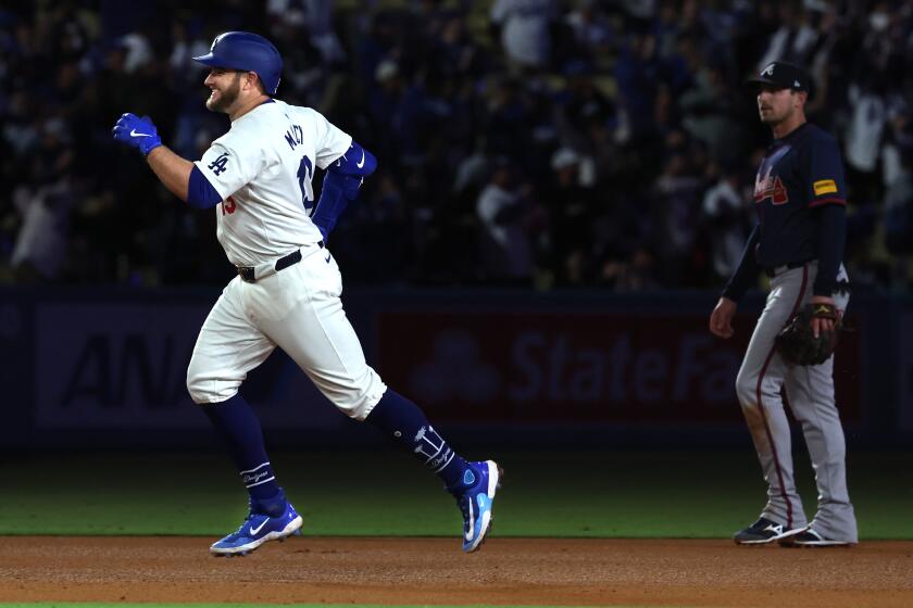 LOS ANGELES, CALIFORNIA-May 4, 2024- Dodgers Max Muncy round the bases after hitting his third home run against the Braves in the eighth inning at Dodger Stadium Saturday. (Wally Skalij/Los Angeles Times)