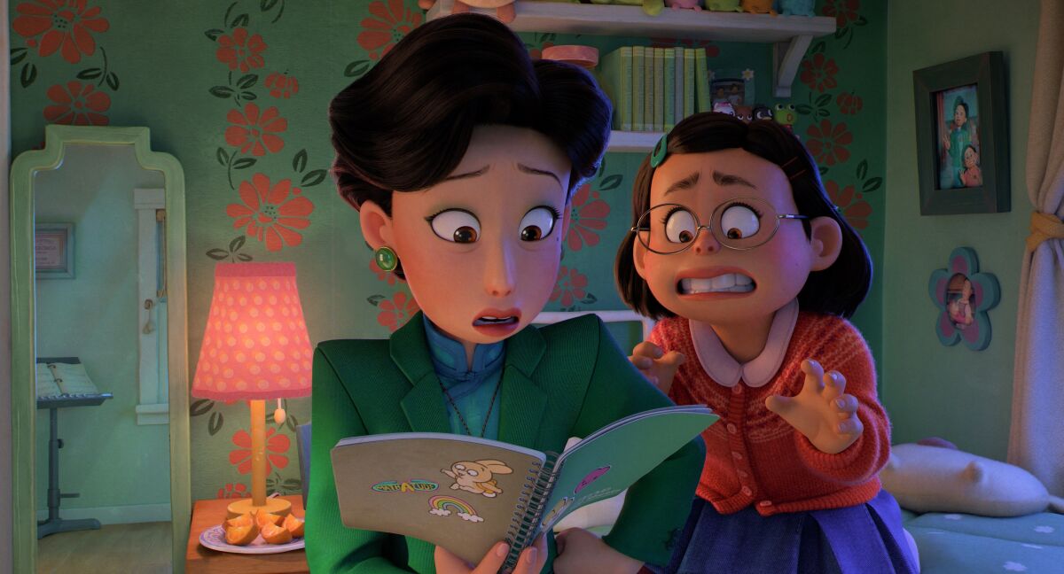 A mother reads a book while her daughter looks on in annoyance in a scene from the animated movie "Turning Red."