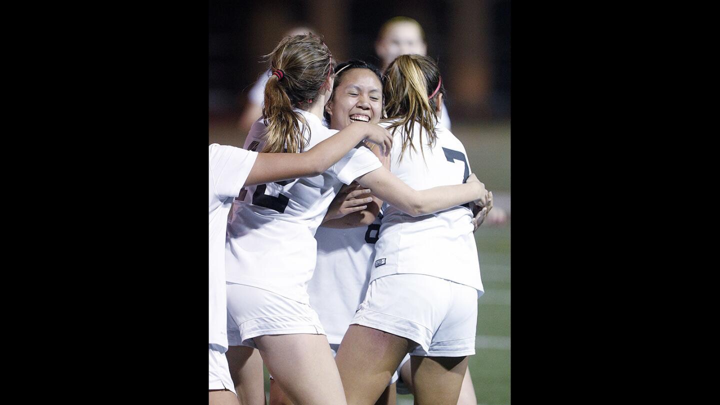 Flintridge Sacred Heart Academy's Amethyst Trang is embraced by her team after scoring a goal against Chaminade in a Mission League girls' soccer game at St. Francis High School on Monday, February 5, 2018. By winning 1-0, Flintridge Sacred Heart Academy secures first place in the Mission League.