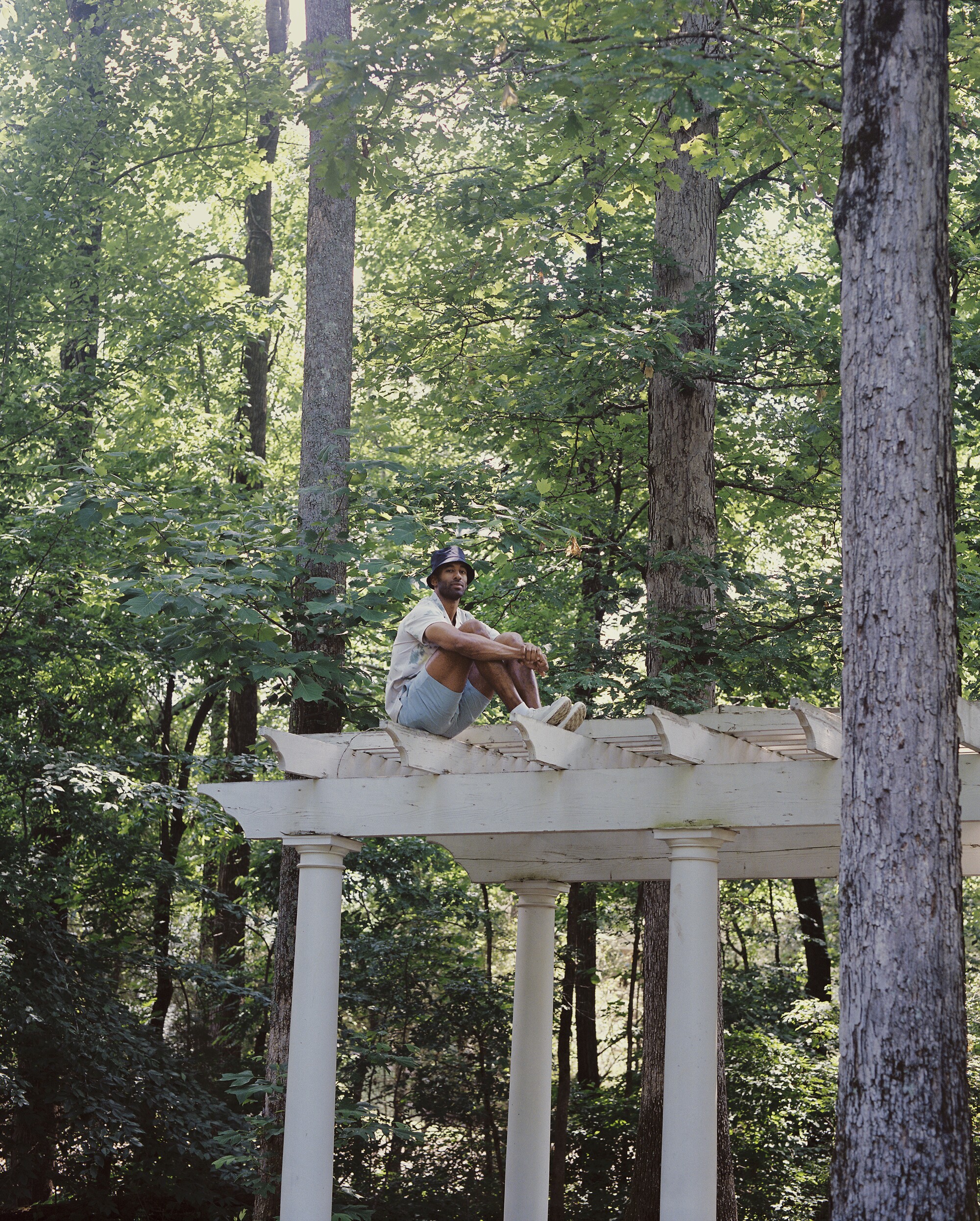A man sits on a wooden deck.