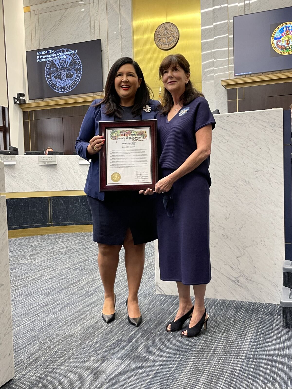 Supervisor Nora Vargas, left, presents a proclamation to SBCS CEO Kathie Lembo for the nonprofit's 50 years of service.