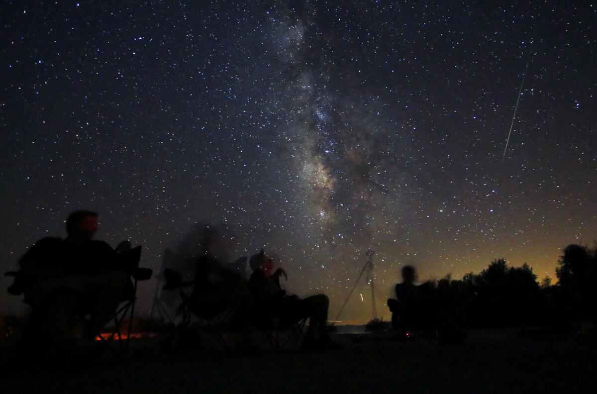 Stargazers watch the annual Perseid meteor shower in Anza-Borrego Desert State Park. The Geminid shower, which peaks Saturday night, is expected to put on an even more prolific show.