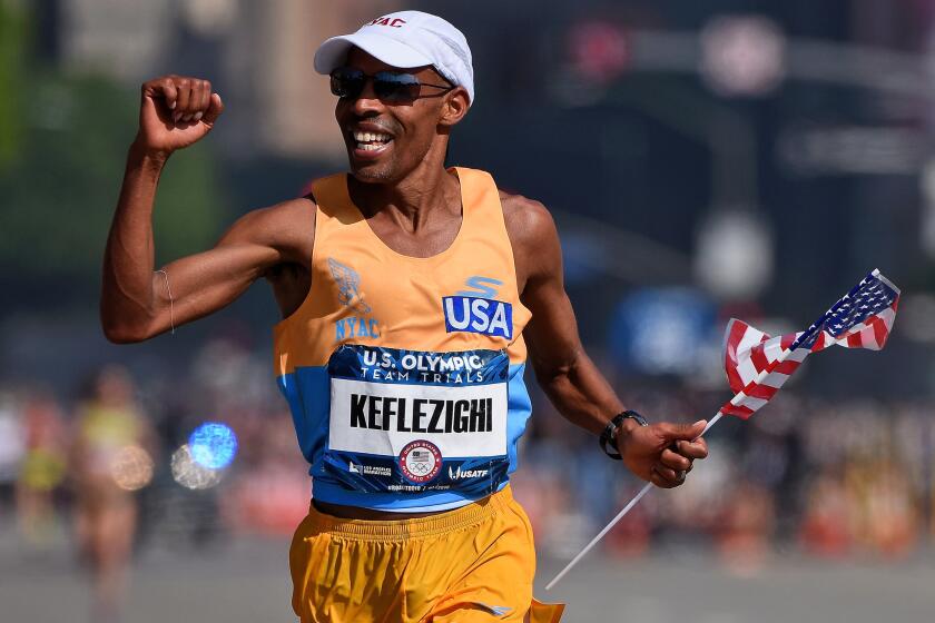 FEBRUARY 13, 2016: Second place runner Meb Keflezighi celebrates as he approaches the finish line during the U.S Olympic Marathon Team Trials on February 13, 2016 in Los Angeles, California.