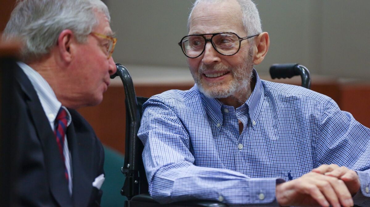 New York real estate scion Robert Durst has a lighter moment with one of his attorneys, Dick DeGuerin, while appearing in Los Angeles court earlier this year for a hearing in his murder case.