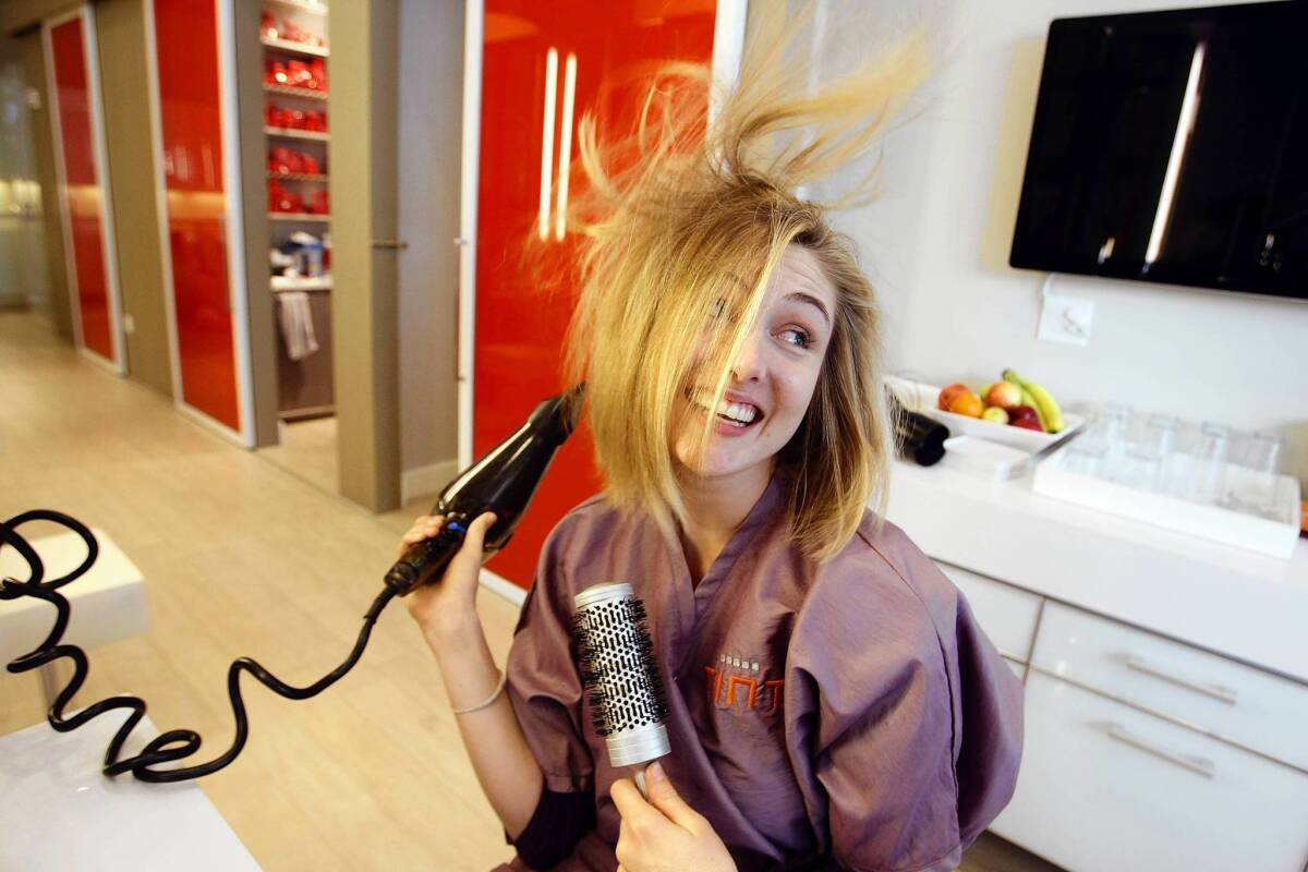 Joanna Bateman dries her own hairat Tint, a hair color studio in Santa Monica.