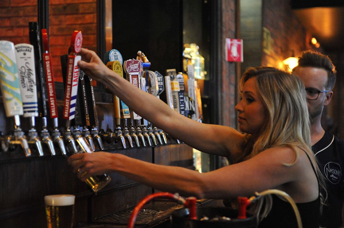 Celebrity reporter Heather Lake pours a beer at Nason's Beer Hall Bartending Charity Event in April 2019.