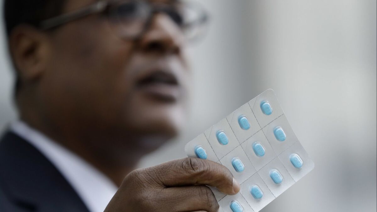 Bill Cosby's spokesman Andrew Wyatt holds up a package of Benadryl tablets as he speaks to the media during a break in Cosby's sexual assault trial.