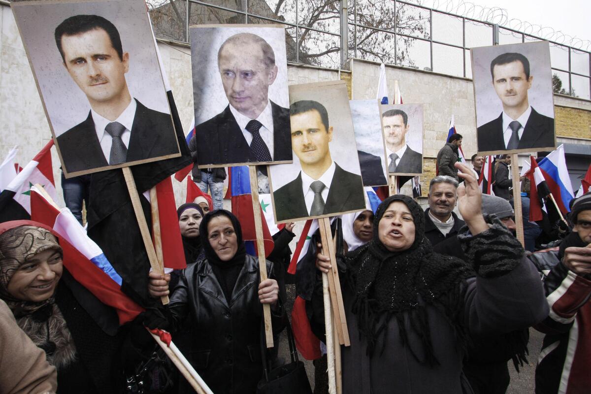 Pro-government Syrians rally on March 24, 2012, in Damascus in support of President Bashar Assad and his ally, Russian President Vladimir Putin.
