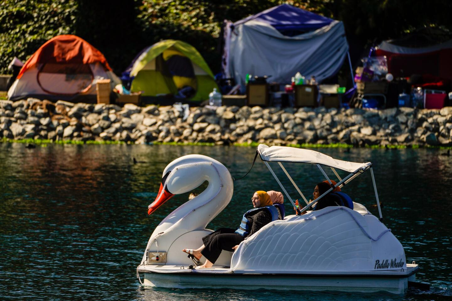 LOS ANGELES, CA - OCTOBER 13: People aboard a pedal boat on the water at the lake at Echo Park on Tuesday, Oct. 13, 2020 in Los Angeles, CA. More unseasonably warm weather is on tap for California this week, with officials warning that a combination of high temperatures and gusty winds will heighten fire danger throughout much of the state with Red Flag warnings in effect for parts of the state. (Kent Nishimura / Los Angeles Times)