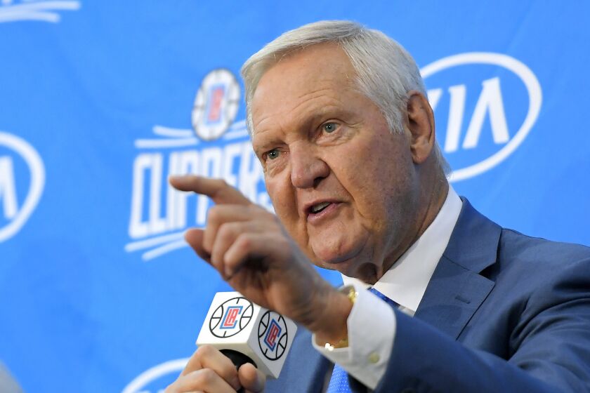  Jerry West points as he speaks during a news conference 