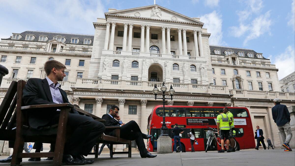 A London bus passes the Bank of England in London.
