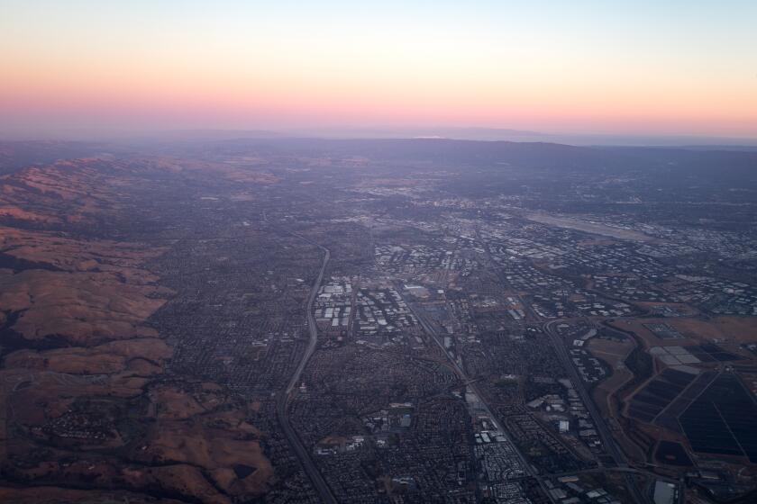 Aerial view of Silicon Valley at dusk, including the towns of Milpitas, Santa Clara, and San Jose, with the Mineta San Jose International Airport visible, California, July, 2016. (Photo by Smith Collection/Gado/Getty Images).