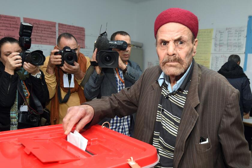 A man casts his vote at a polling station Sunday in Tunis, Tunisia.