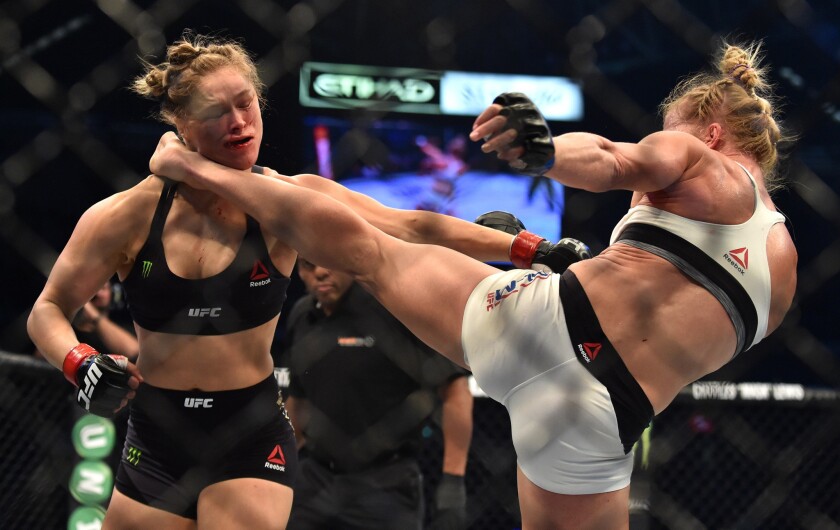 Holly Holm, right, lands a kick to the neck to knock out Ronda Rousey at UFC 193 in Melbourne, Australia, on Nov. 15, 2015.