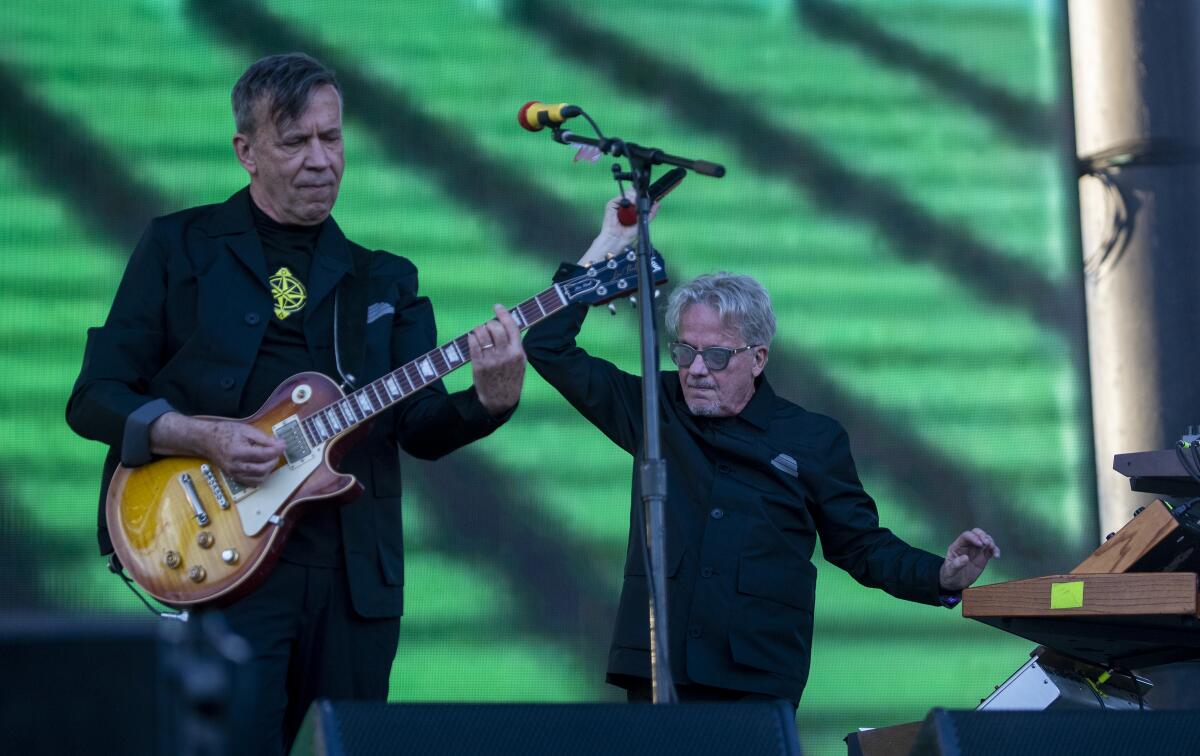 Devo members Mark Mothersbaugh, right, and Bob Mothersbaugh perform at the Cruel World festival on Saturday, May 14, 2022. 