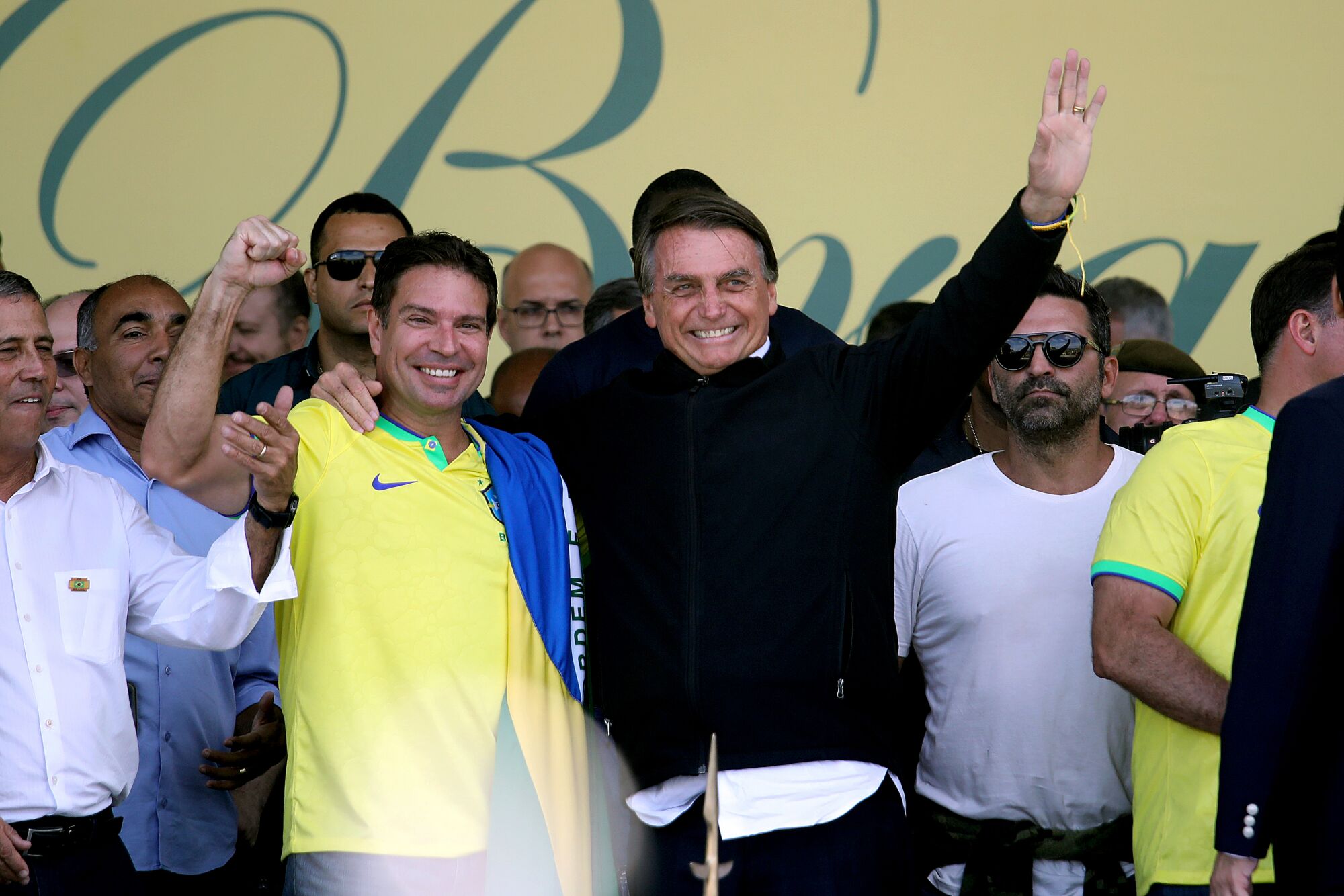 Brazilian President Jair Bolsonaro waves to supporters.