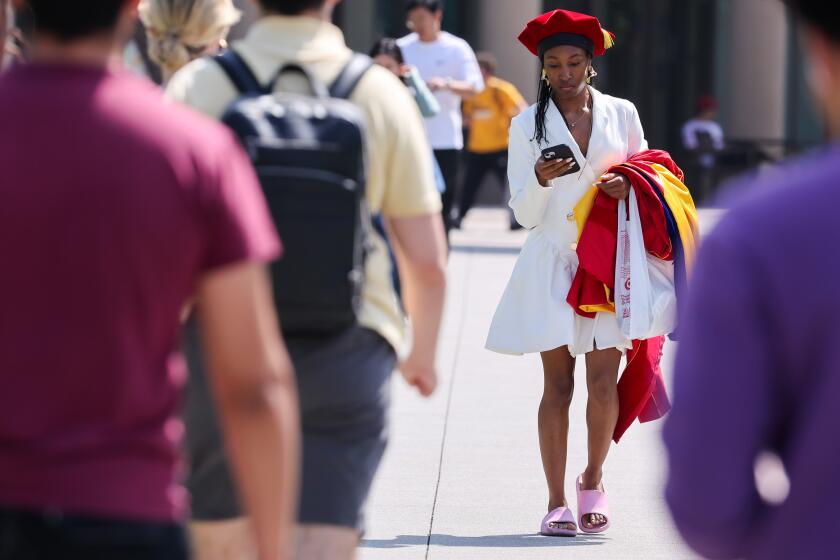 Los Angeles, CA - May 08: Graduate Kayla Love on her way to receive her PhD in biochemistry in a pared down ceremonies at the University of Southern California on Wednesday, May 8, 2024 in Los Angeles, CA. (Brian van der Brug / Los Angeles Times)