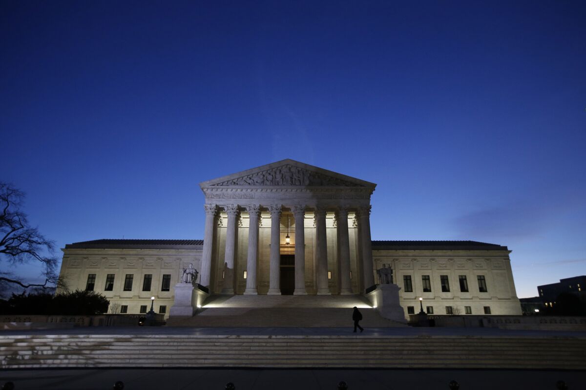 The U.S. Supreme Court building at night.