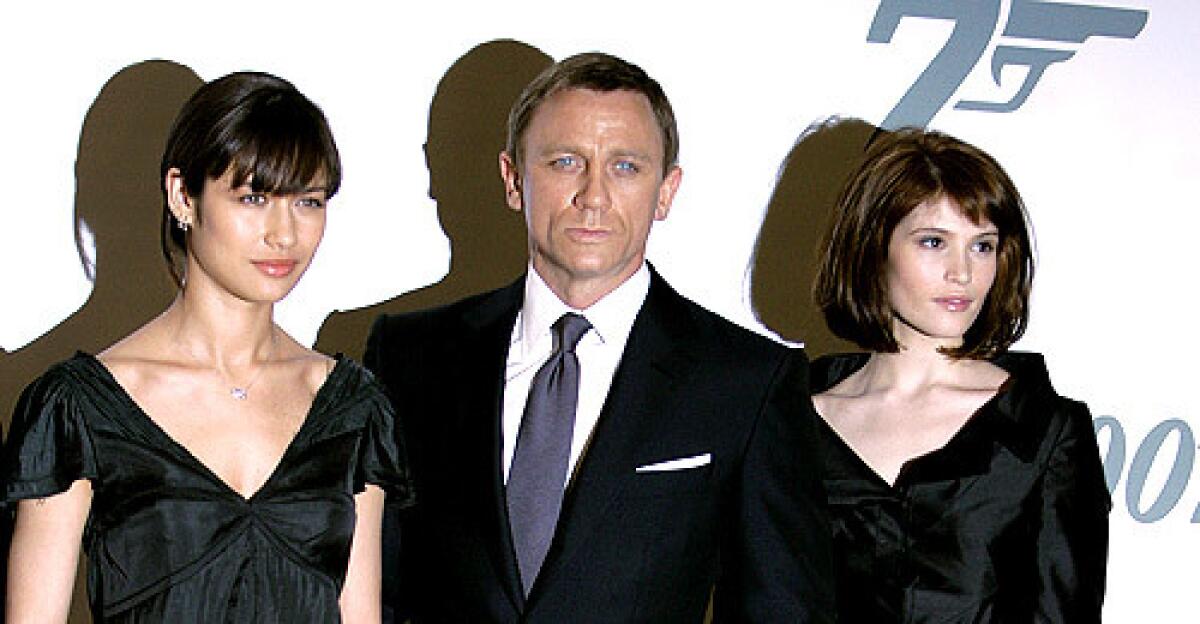 Daniel Craig, James Bond himself, poses with the newest Bond girls to hit the franchise -- Gemma Arterton and Olga Kurylenko -- at the announcement of the name for the latest Bond movie, Quantum of Solace, at Pinewood Studios.