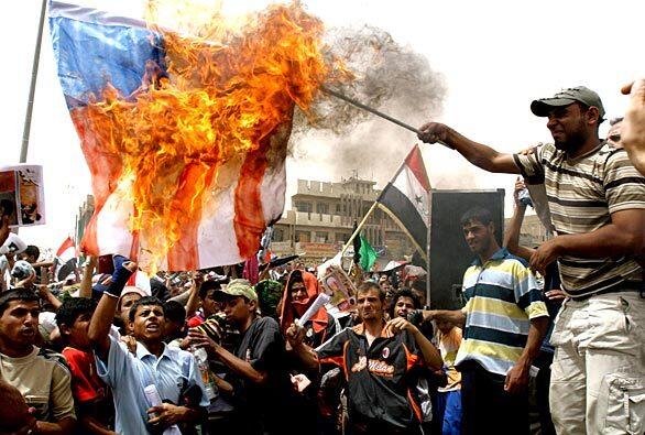 Protesters burn an American flag during a rally in the Shiite enclave of Sadr City in Baghdad. Tens of thousands of Shiite faithful streamed out of mosques to join protests against a security agreement with the United States that could lead to a long-term U.S. troop presence in Iraq.