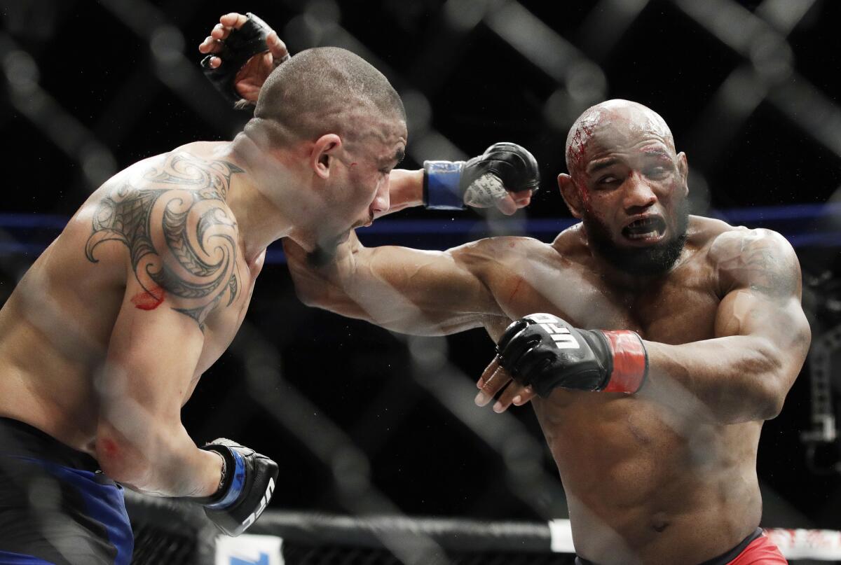 Yoel Romero, right, fights Robert Whittaker in a middleweight championship bout at UFC 213.