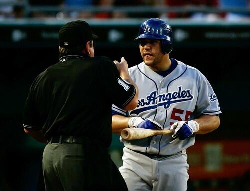 Home plate umpire Charlie Reliford, left, and Dodgers batter Russell Martin argue whether the ball hit the bat.