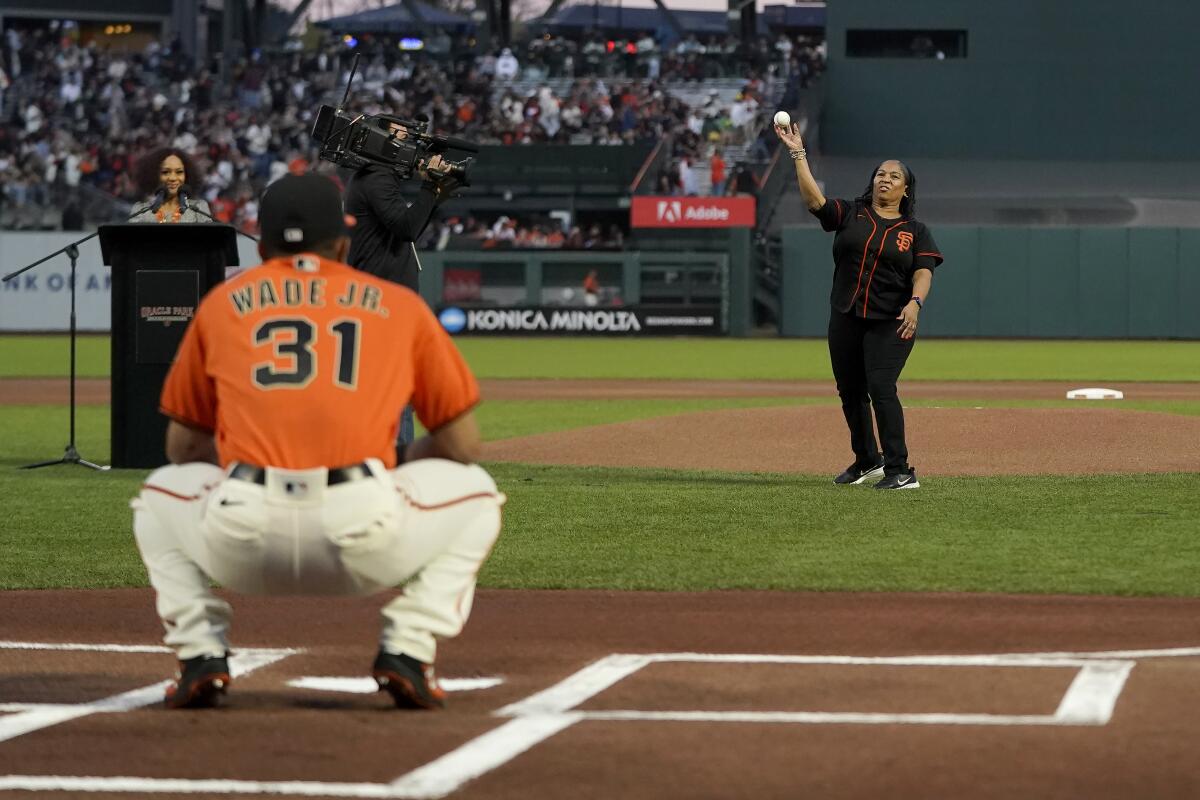 San Francisco's LaMonte Wade Jr. catches the ceremonial first pitch from his mother, Emily, on Oct. 1, 2021.