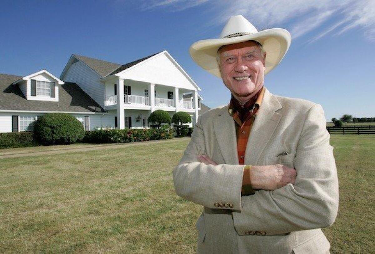 Larry Hagman poses in front of Southfork Ranch, the Ewing homestead from the TV show "Dallas."